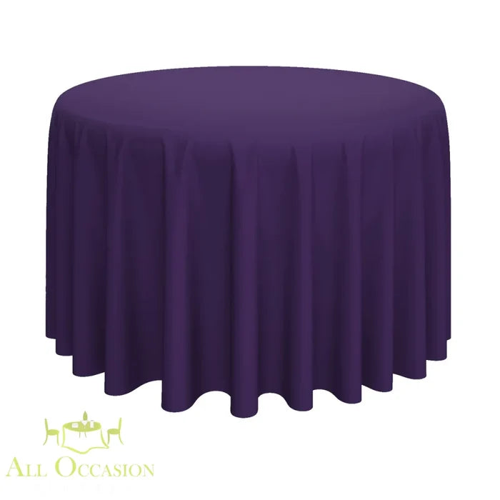 132 Inch Round Polyester Tablecloth Eggplant draped over a round table, perfect for elegant events by All Occasion Rentals.