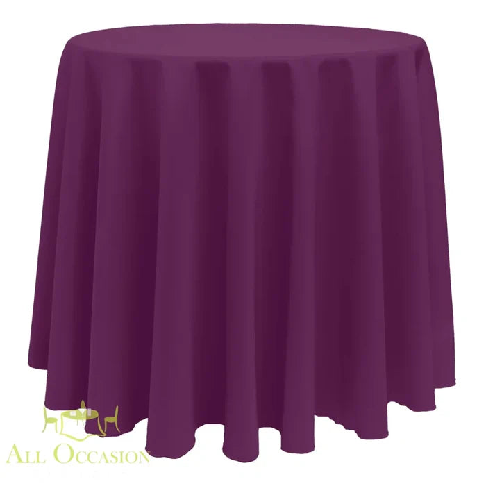 132 Inch Round Polyester Tablecloth Plum draped over a round table for elegant events and occasions.