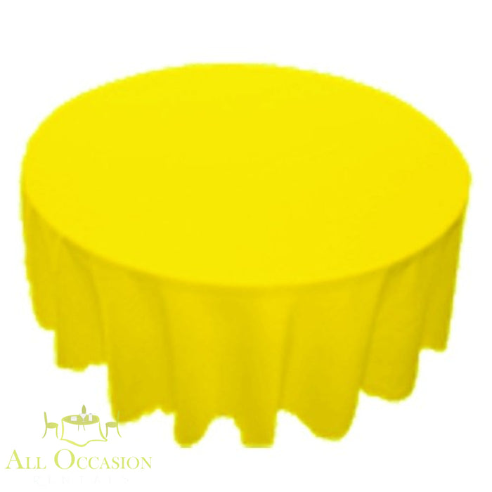 90 inch Round Polyester Tablecloth Lemon on a round table, bright yellow color for festive occasions.