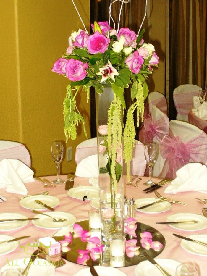 Elegant centerpieces with pink roses for events at Corona party rentals, ideal for weddings and receptions.