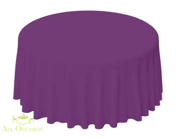 132 Inch Round Polyester Tablecloth Plum on a round table, suitable for upscale events and weddings.