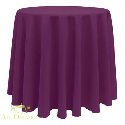 132 Inch Round Polyester Tablecloth Plum draped over a round table for elegant events and occasions.