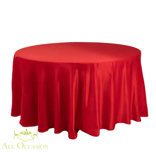 132 Inch Round Polyester Tablecloth Satin Red on a round table, perfect for weddings and elegant events.
