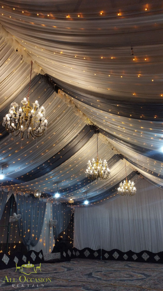 Elegant event setup with 8 crystal chandeliers and draped decor for Corona event rentals.