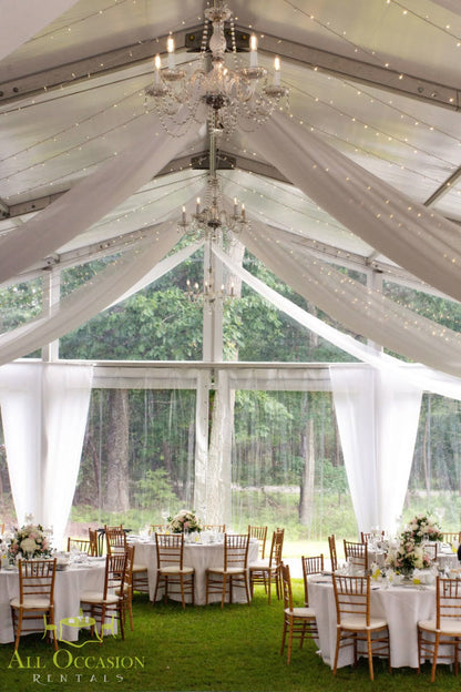 Elegant 8 crystal chandelier lights in a tent for event rentals in Corona, featuring stylish chiavari chairs and table linen.