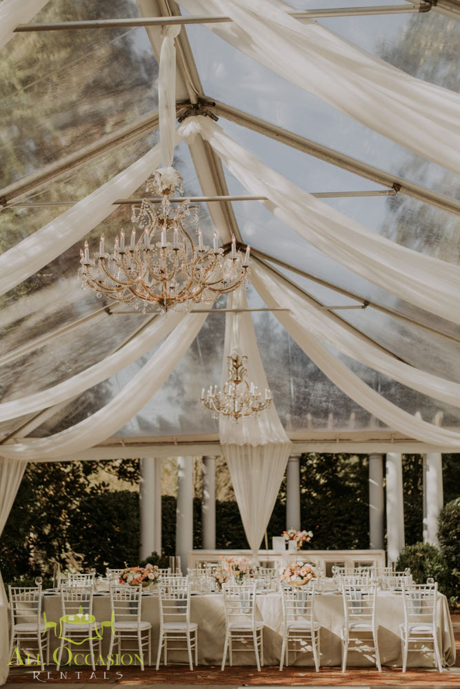 Elegant 8 crystal chandelier lights enhance a luxurious tent setup for Corona event rentals.
