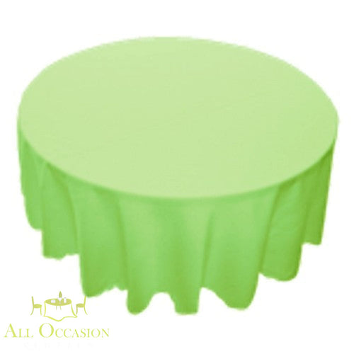90 inch Round Polyester Tablecloth Lime on a round table, perfect for events and parties.