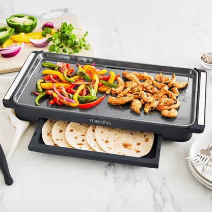 Enjoy a family-sized brunch with the Advanced Griddle with Warming Drawer | Graphite, cooking chicken strips and bell peppers on top while the drawer keeps flour tortillas warm. Serve with fresh vegetables and cilantro for a delicious meal.