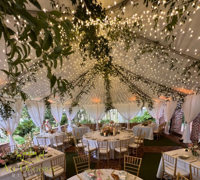 Bistro Lighting Rental 37.5ft white string lights create an inviting atmosphere for events under a beautifully decorated tent.