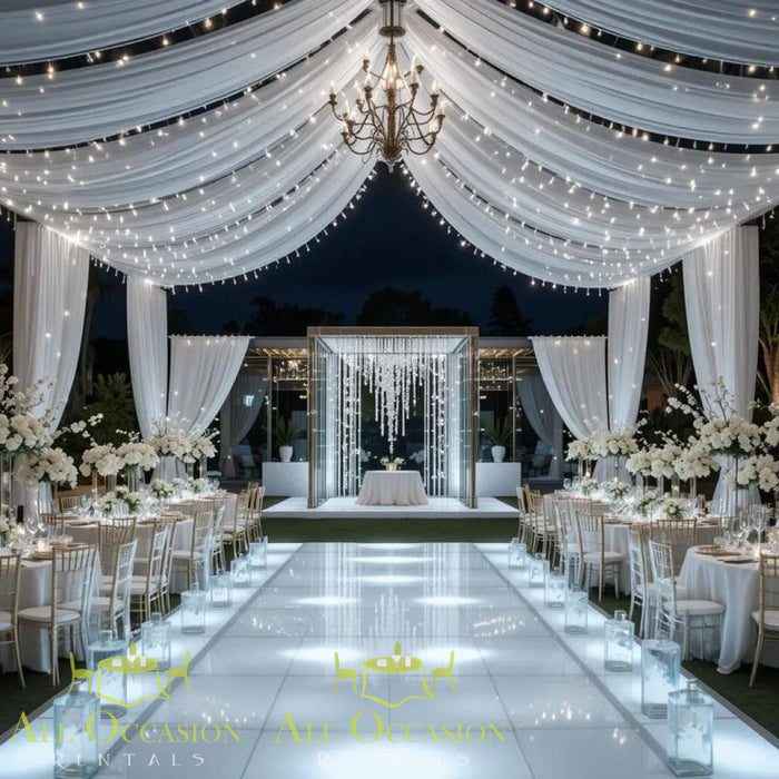 Bistro Lighting Rental 37.5ft white string lights illuminating an elegant wedding reception with tables and decorations.