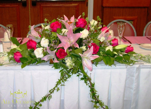 Beautiful Center Pieces Flower arrangement with pink roses and lilies for elegant event decor.