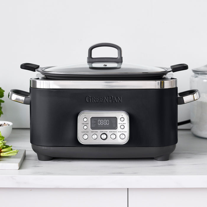 Black slow cooker with digital display on a white countertop