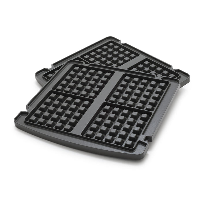 Pair of square waffle plates with grid pattern, stacked slightly offset on a white surface.