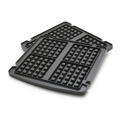 Pair of square waffle plates with grid pattern, stacked slightly offset on a white surface.
