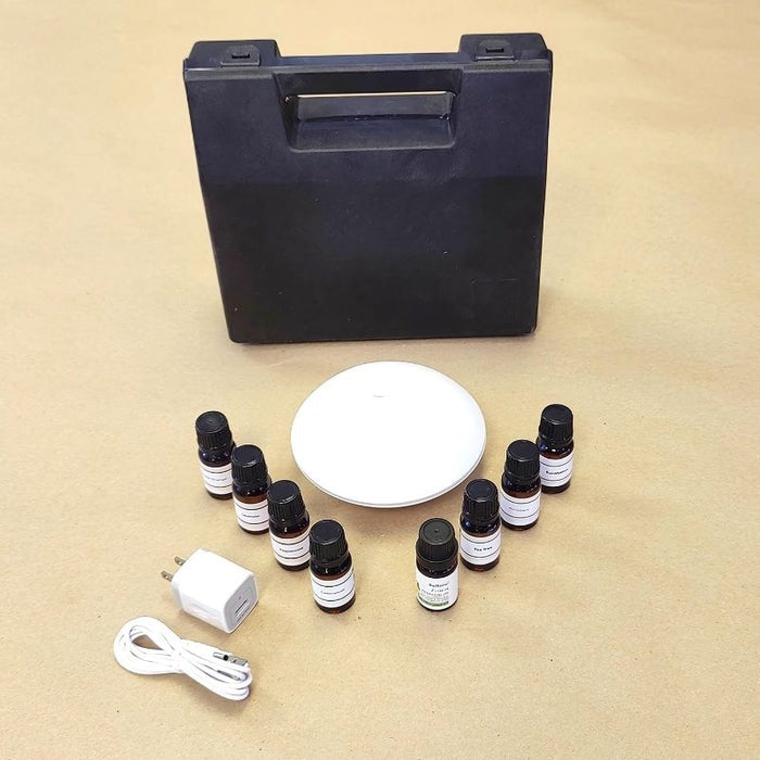 Experia Aroma Starter Kit top view showing the complete set with USB-powered aroma diffuser, sturdy carrying case, and eight 10ml essential oils for sensory room aromatherapy