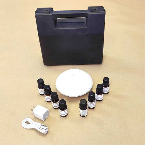 Experia Aroma Starter Kit top view showing the complete set with USB-powered aroma diffuser, sturdy carrying case, and eight 10ml essential oils for sensory room aromatherapy