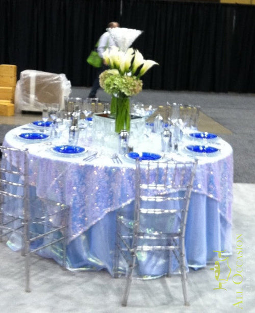 Floral Centerpiece Rental Design 30 displayed on an elegant event table with blue plates and silver chairs.