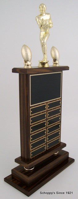 Side View of A large Football Perpetual Trophy by Schoppy's. The trophy features a Large Football Runner Figure and comes with decorative acorn trim. The front of the base displays a large black laser-engraved heading plate, accompanied by 12 smaller individual plates for recording past winners