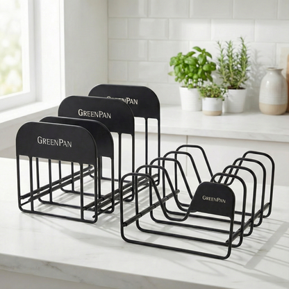 Two black metal organizers on a white kitchen counter, shown with herbs and ceramic vases nearby.