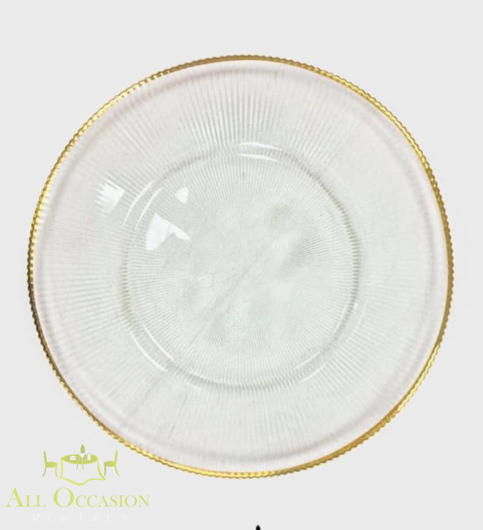 Glass Charger Plate with Gold Rim Rental featuring clear glass with a decorative gold rim for elegant events.