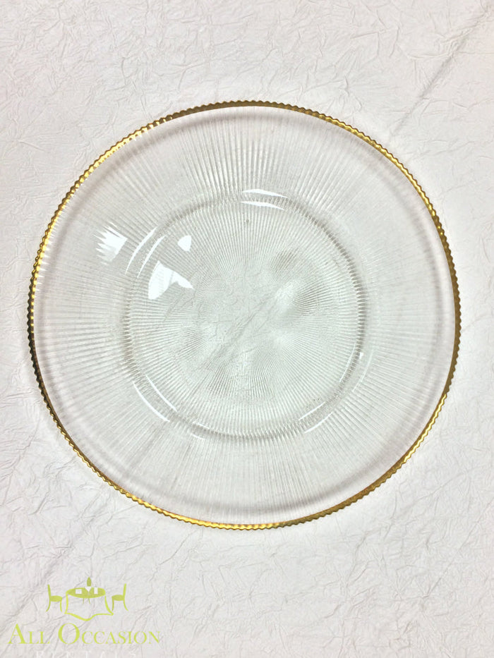 Glass Charger Plate with Gold Rim Rental on a textured background, showcasing elegance and sophistication