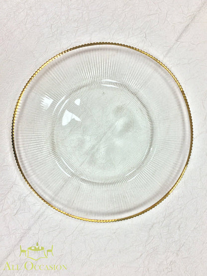Glass Charger Plate with Gold Rim Rental on a textured background, showcasing elegance and sophistication