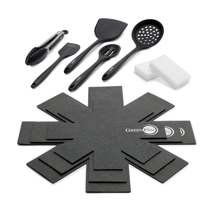 Accessory kit with black cooking utensils, white sponges, and gray pan protectors arranged on a white background.