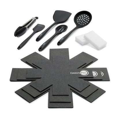 Accessory kit with black cooking utensils, white sponges, and gray pan protectors arranged on a white background.