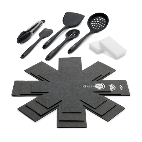 Accessory kit with black cooking utensils, white sponges, and gray pan protectors arranged on a white background.