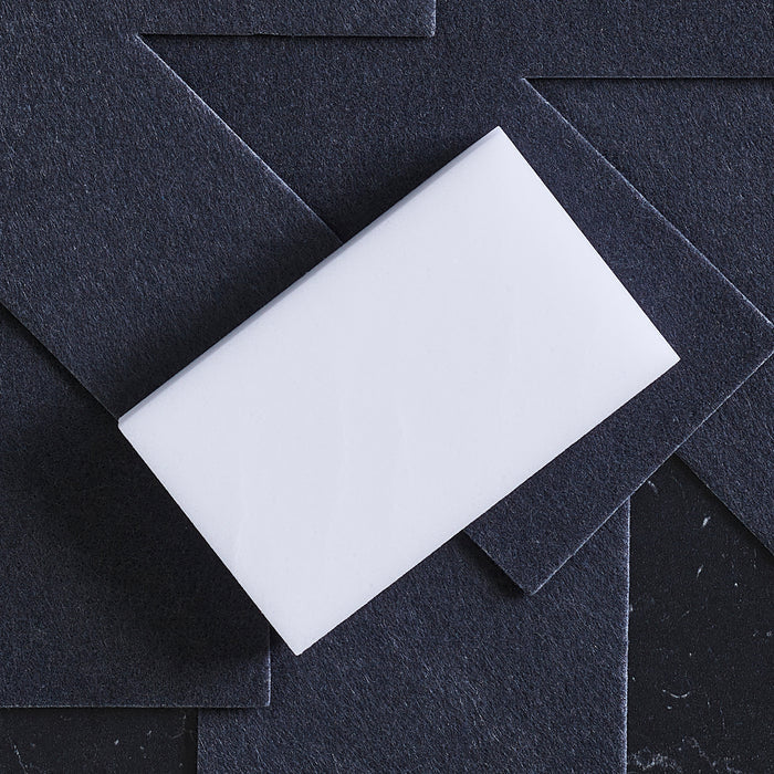 GreenPan accessory kit on layered black textured sheets, resembling stacked cookware on a dark background.