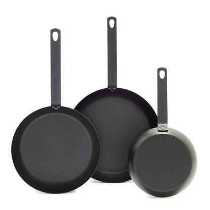 Set of three carbon steel frypans with long handles, sizes 8, 10, and 12, shown upright.