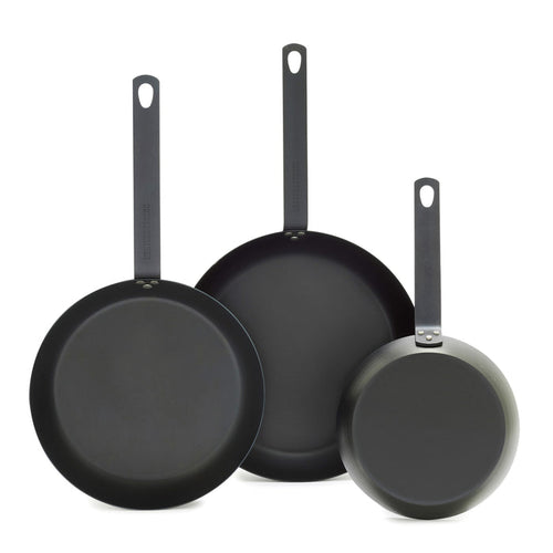 Set of three carbon steel frypans with long handles, sizes 8, 10, and 12, shown upright.