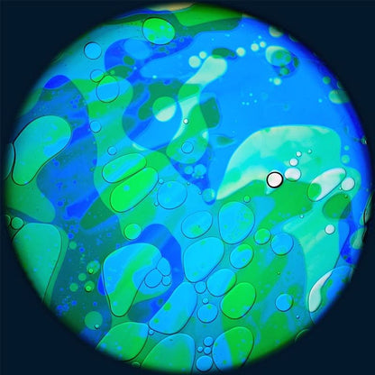 OPTIKinetics 6 inch Liquid Effect Wheel Ocean Breeze showing the cool-toned oil-based lava lamp projection effect for calming sensory rooms and therapeutic spaces