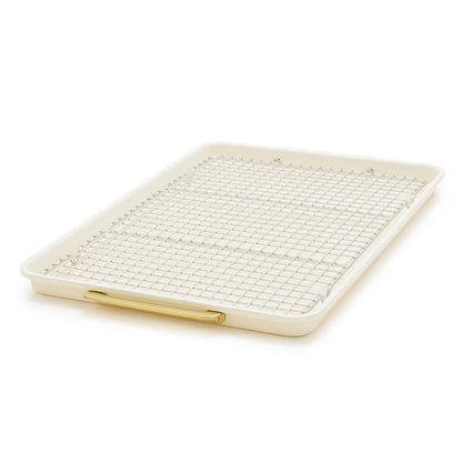 Cream half sheet pan with gold-tone handles and matching cooling rack, nonstick finish, two-piece set.