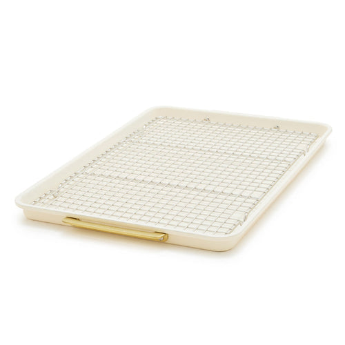 Cream half sheet pan with gold-tone handles and matching cooling rack, nonstick finish, two-piece set.