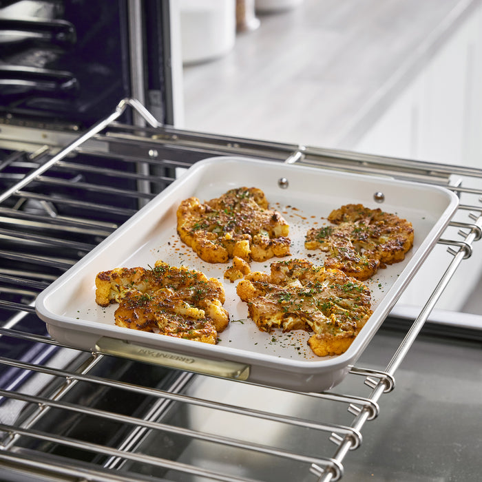Roasted cauliflower on a 13″ x 9″ Reserve Bakeware quarter sheet pan inside an oven.
