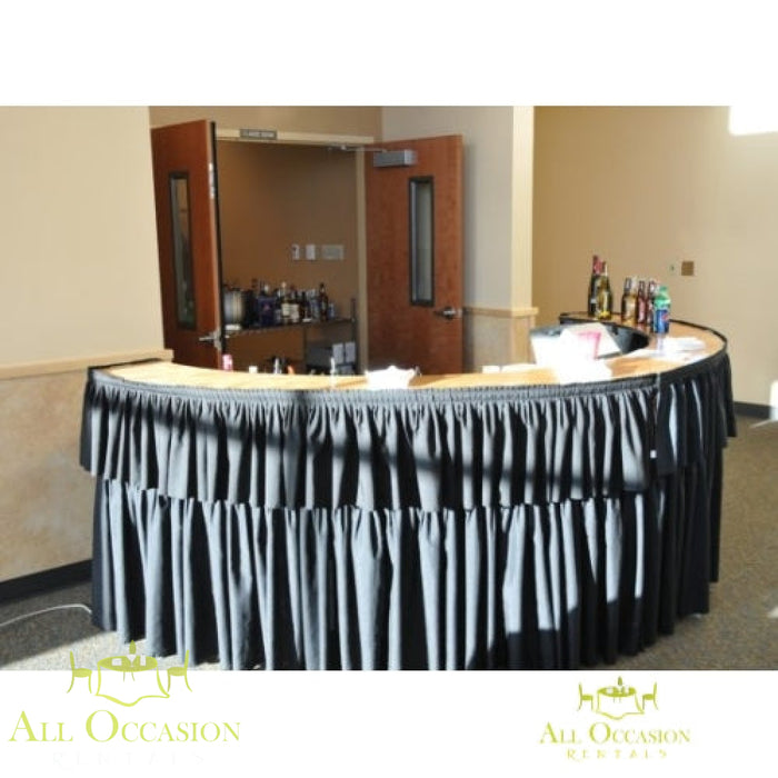 Serpentine Bar with Black Draping rental featuring a curved design and sleek black draping for events.