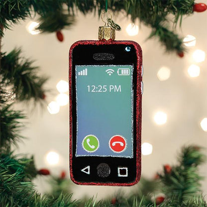 A Christmas tree ornament shaped like a smartphone hangs among green branches and twinkling lights. The ornament displays a screen with call icons and the time 12:25 PM.