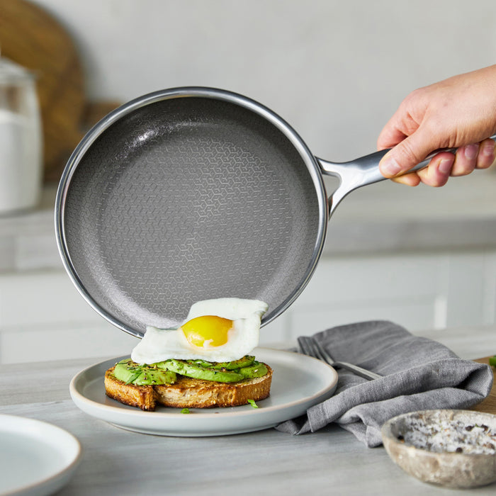 Spectra Diamond Thermobond hybrid ceramic nonstick 8″, 10″, and 12″ frypan set held over avocado toast with a fried egg.