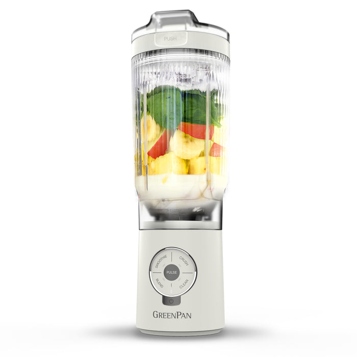 White portable blender with fruits inside on a white background, featuring the GreenPan brand.