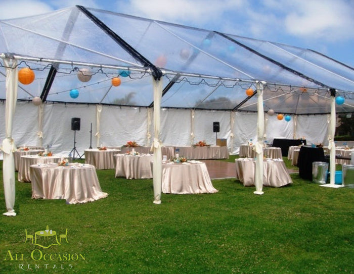 Elegant outdoor event setup under a tent with decorated tables, featuring Tent Leg Covers Ivory 8' for a polished look.