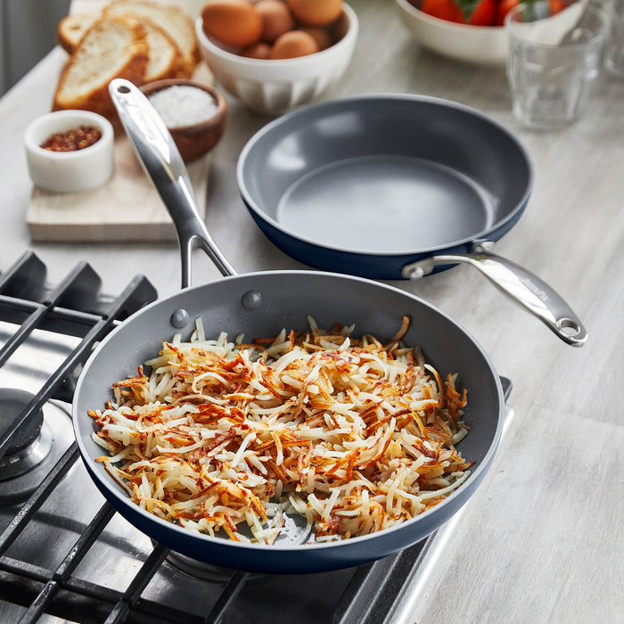 Cooking hashbrowns in a frypan on a gas stove