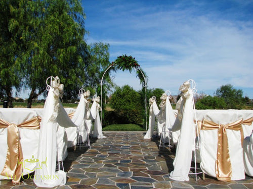 Wedding Arch Rental white iron with draping and stands set up for a beautiful outdoor ceremony.