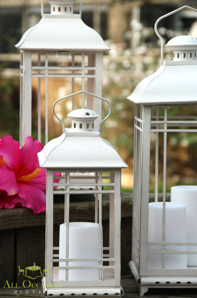 White metal lanterns medium with candles, perfect for romantic event lighting décor and outdoor celebrations.
