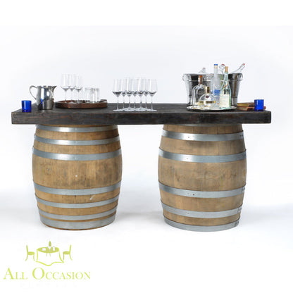 Wine barrel bar or table featuring a wooden top and two sturdy barrels, perfect for entertaining.